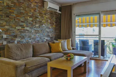 a living room with a couch and a table at 3 bedroom Huge apartament near the beach in Sant Adria de Besos