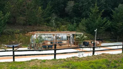 a boat with a house on top of it at Caravana Airstream Vintage del 67 en Orrius, Barcelona in Orrius