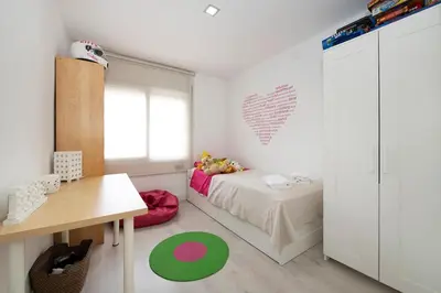 a bedroom with a bed and a desk and a table at Namasté by Seaside Homes in Castelldefels