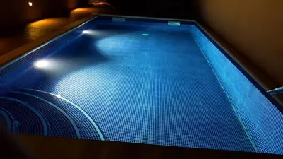 a large swimming pool with blue lights on it at Casa grande con piscina en el centro de Calella, Tramuntana in Calella