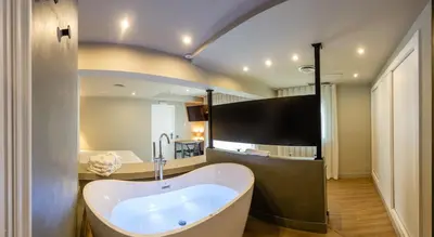 a large bathroom with a tub in the middle at Mas de la Sala in Sallent del Llobregat