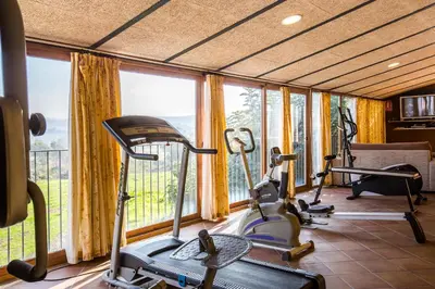 a gym with several exercise bikes in a room with windows at Mas de la Sala in Sallent del Llobregat