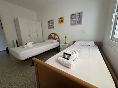 two beds in a room with two beds sidx sidx sidx at Apartamento Pineda de Mar en Primera Línea in Pineda de Mar