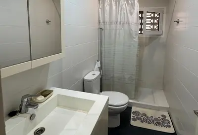 a bathroom with a sink and a toilet and a shower at Apartamento Pineda de Mar en Primera Línea in Pineda de Mar