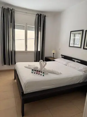 a bedroom with a bed with two pillows on it at Apartamento Pineda de Mar con Vistas al Mar in Pineda de Mar