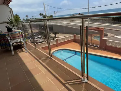 a balcony with a swimming pool on top of a building at Apartamento Pineda de Mar con Vistas al Mar in Pineda de Mar