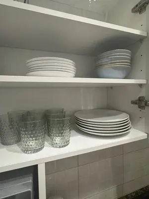 a kitchen shelf with plates and bowls on it at The Perfect Nomad's Home - Barcelona in Barcelona
