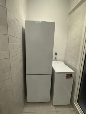 a white refrigerator in a bathroom with a sink at The Perfect Nomad's Home - Barcelona in Barcelona