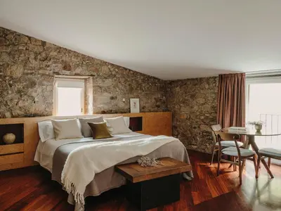 a bedroom with a large bed and a table at Paratgea in Llinars del Vallès