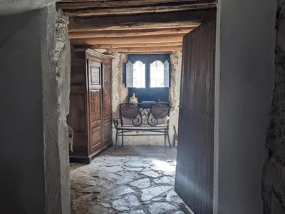 a hallway with a bench in a room with a window at La Coma in gualba de Dalt