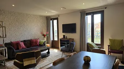 a living room with a couch and a table at Opening Doors Summer Chic in Barcelona