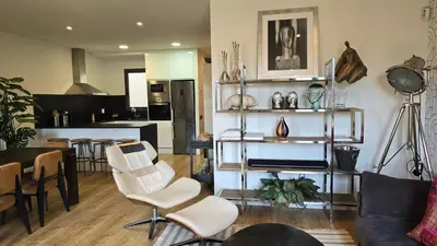 a living room and kitchen with a table and chairs at Opening Doors Summer Chic in Barcelona