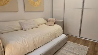 a couch with two pillows on it in a room at Opening Doors Summer Chic in Barcelona