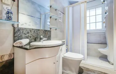 a bathroom with a sink and a toilet at Lovely Home In Segur De Calafell in Segur de Calafell