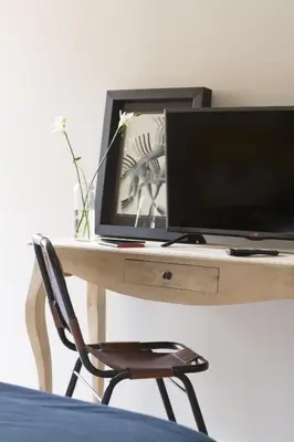 a desk with a computer monitor and a chair at The Conica Deluxe Bed&Breakfast in Barcelona