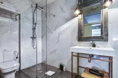 a bathroom with a shower and a sink and a mirror at The Conica Deluxe Bed&Breakfast in Barcelona