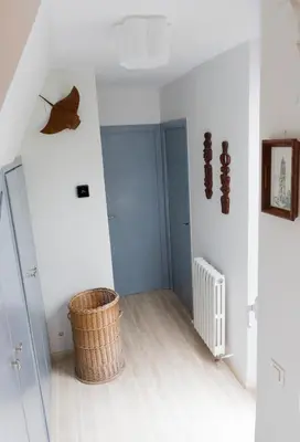 a room with white walls and a wicker basket at Stunning sea views over marina with swimming pool in Sitges