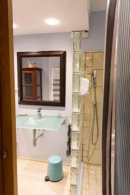 a bathroom with a sink and a shower at Stunning sea views over marina with swimming pool in Sitges