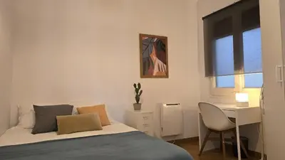 a bedroom with a bed and a desk and a window at Opening Doors Sant Pau II Centric AACC in Barcelona