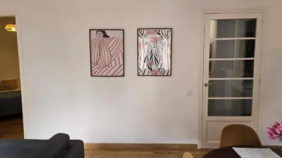 a living room with three pictures on the wall at Opening Doors Sant Pau II Centric AACC in Barcelona