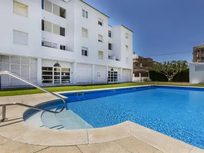a swimming pool in front of a building at Apartment Bahia by Interhome in Cunit