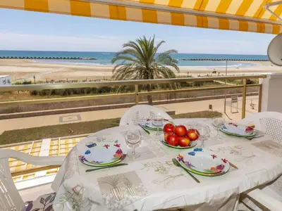 a table with a plate of fruit and a view of the beach at Apartment Bahia by Interhome in Cunit