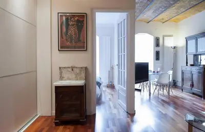a living room with a television and a dining room at Barcelona - Provença in Barcelona