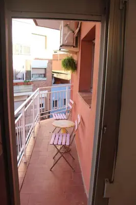 a balcony with a table and two chairs on a balcony at 2º Apartamento 3 hab 15' Barcelona centro y 8' Playa caminando in Sant Adria de Besos