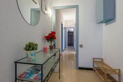 a hallway with a glass table and a mirror at 2º Apartamento 3 hab 15' Barcelona centro y 8' Playa caminando in Sant Adria de Besos