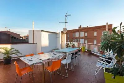 a patio with a table and chairs on a balcony at 2º Apartamento 3 hab 15' Barcelona centro y 8' Playa caminando in Sant Adria de Besos