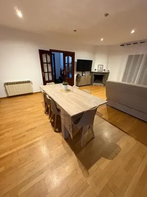 a living room with a wooden table and a couch at casa en Palau in Palau-Solità i Plegamans