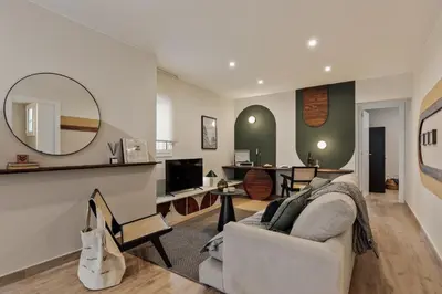 a bedroom with a large bed with a wooden headboard at Balat - 2 bedrooms and terrace in Eixample Dreta in Barcelona