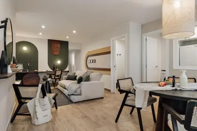 a white bathroom with a toilet and a sink at Balat - 2 bedrooms and terrace in Eixample Dreta in Barcelona