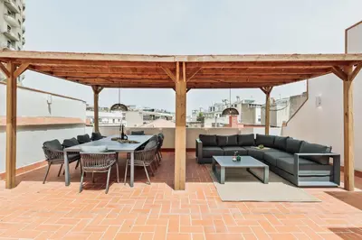 a kitchen and living room with a table and a couch at Agropoli - 2 bedrooms and terrace in Ciutat Vella in Barcelona