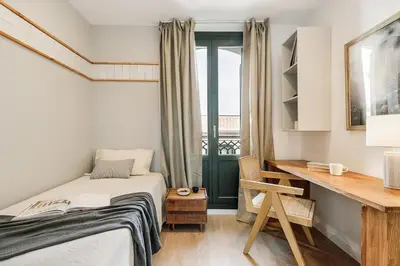 a living room with a couch and a table at Agropoli - 2 bedrooms and terrace in Ciutat Vella in Barcelona