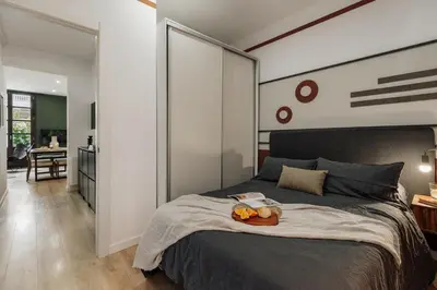 a bedroom with a bed with a tray of fruit on it at Cinar - 2 bedrooms and balcony in Sant Antoni in Barcelona