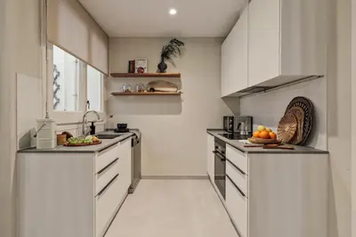 a bathroom with a tub and a table and windows at Cember - 3 bedrooms and patio in Sant Gervasi in Barcelona