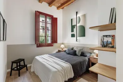a living room with a table and chairs and a couch at Estiu - 2 bedrooms and balcony in Sant Antoni in Barcelona
