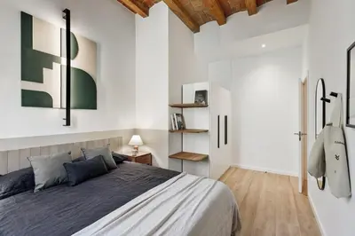 a bedroom with a large bed with two night stands at Estiu - 2 bedrooms and balcony in Sant Antoni in Barcelona