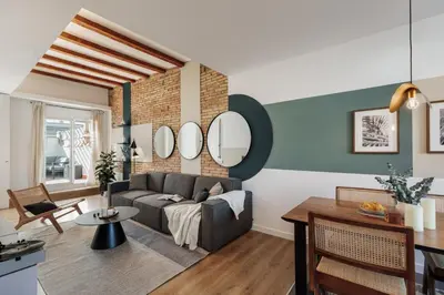 a living room with a couch and mirrors on the wall at Lygos - 2 bedrooms and terrace in Eixample Esquerra in Barcelona
