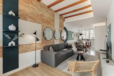 a kitchen with white cabinets and a sink and windows at Lygos - 2 bedrooms and terrace in Eixample Esquerra in Barcelona