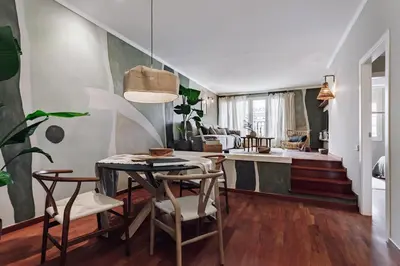 a dining room and living room with a table and chairs at Holo - 2 bedrooms in Eixample Dreta in Barcelona