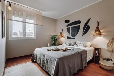 a living room with a tv and a chair and a table at Holo - 2 bedrooms in Eixample Dreta in Barcelona