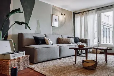 a living room with a couch and a table at Holo - 2 bedrooms in Eixample Dreta in Barcelona