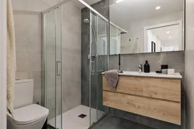 a bedroom with a large bed with a wooden headboard at Arenal - 3 bedrooms and terrace in Sarrià in Barcelona