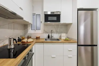 a desk with a chair and a desk with a lamp at Llaberia - 2 bedrooms in Sant Gervasy in Barcelona