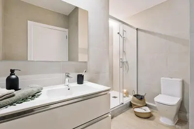 a kitchen and dining room with a table and chairs at Isola - 1 bedroom and terrace in Eixample Dreta in Barcelona