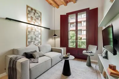a living room with a table and chairs and a couch at Xelida - 2 bedrooms and balcony in Sant Antoni in Barcelona