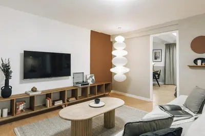 a living room with a tv and a table at Acatenango - 2 bedrooms in El Born in Barcelona