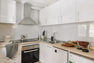 a living room with a table and chairs at Acatenango - 2 bedrooms in El Born in Barcelona